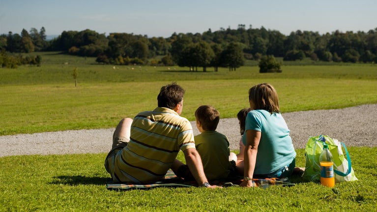 Family enjoying a picnic in the grounds at Florence Court, Co Fermanagh, Northern Ireland